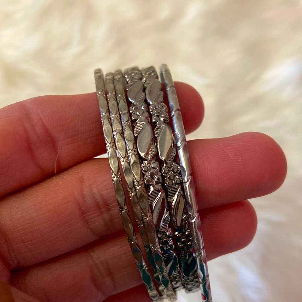 Three pairs of silver tone bracelet